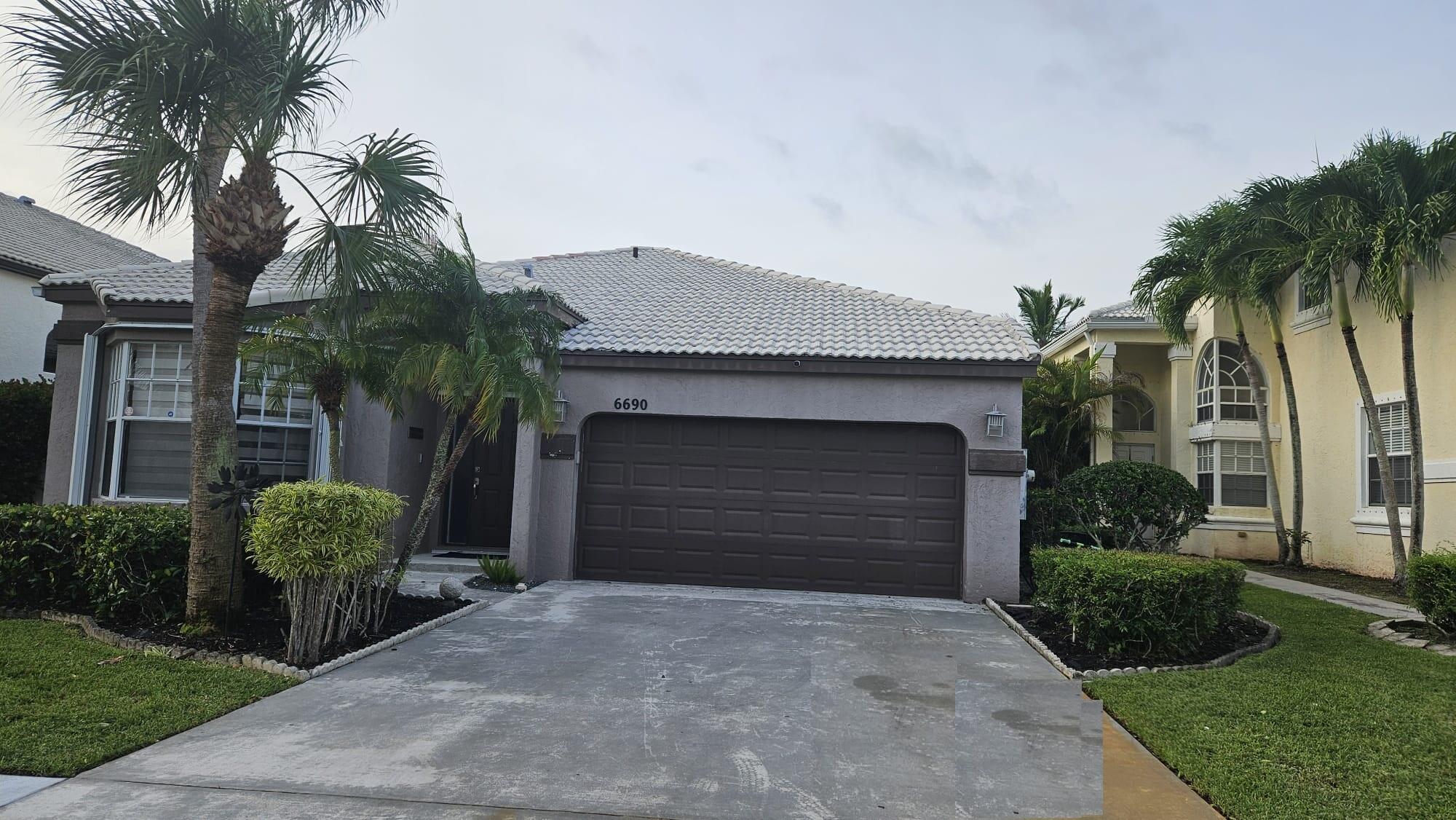 a front view of a house with a yard and a garage