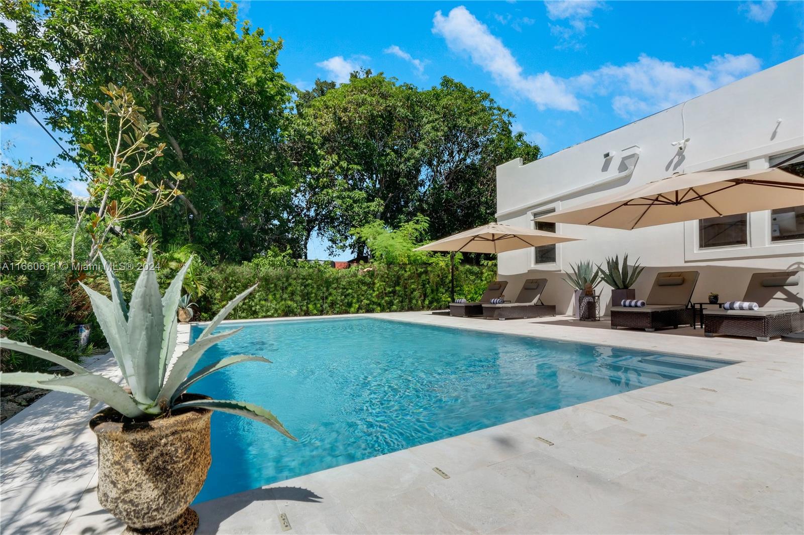 a view of a back yard of the house with a patio