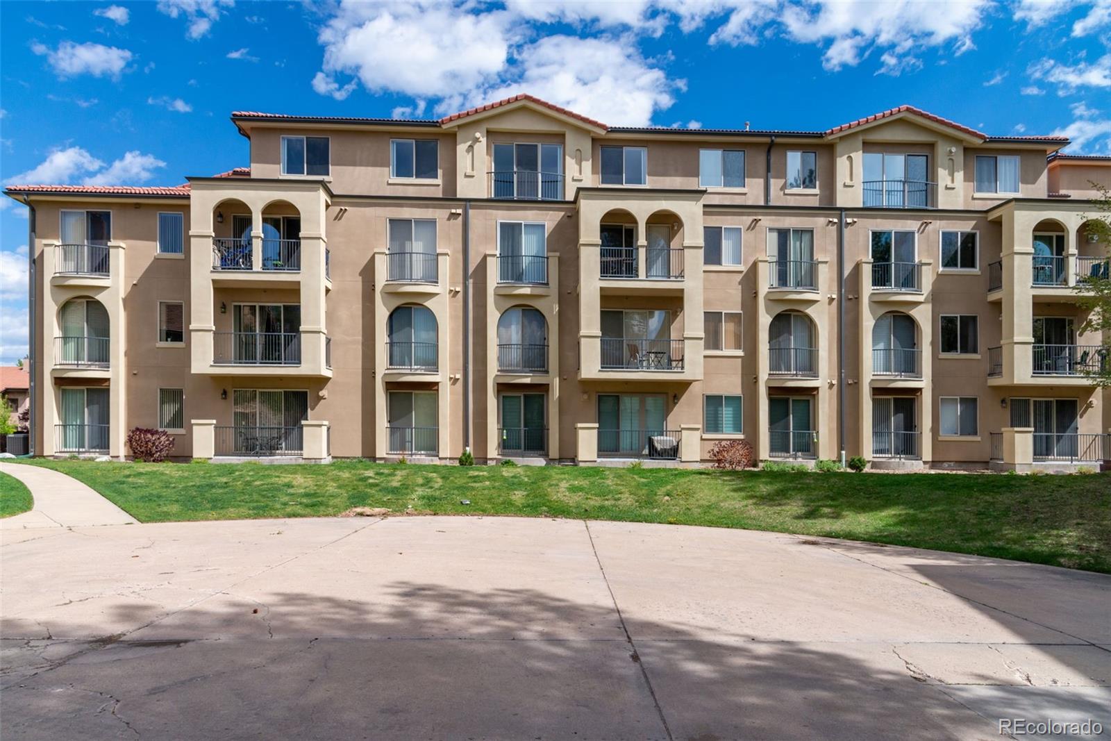 a front view of a residential apartment building with a yard