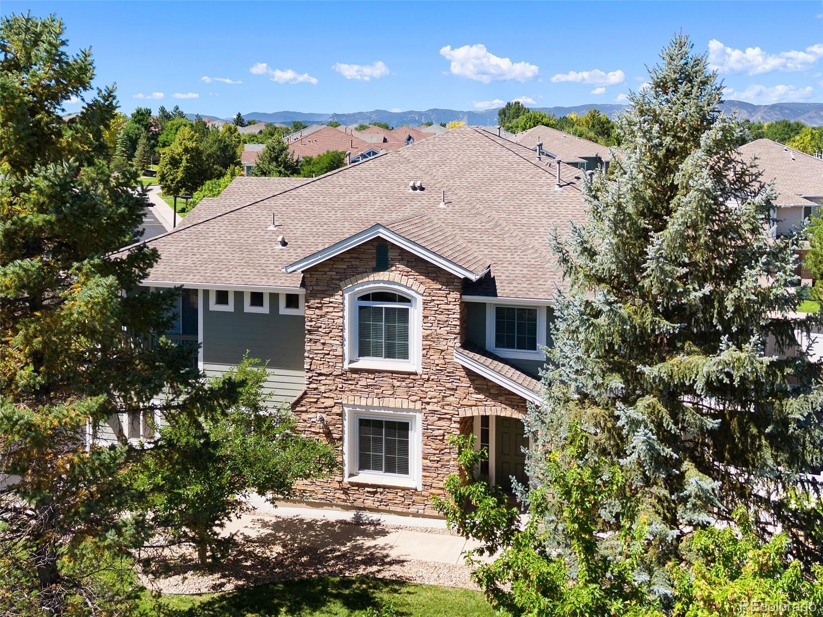 a aerial view of a house with a yard and potted plants