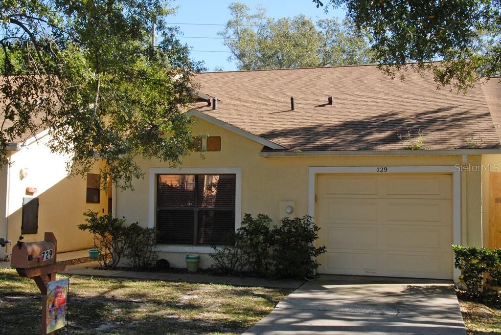 a view of house with outdoor space and swimming pool