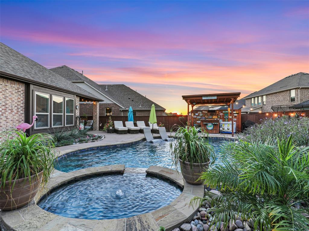 a view of a house with backyard and sitting area