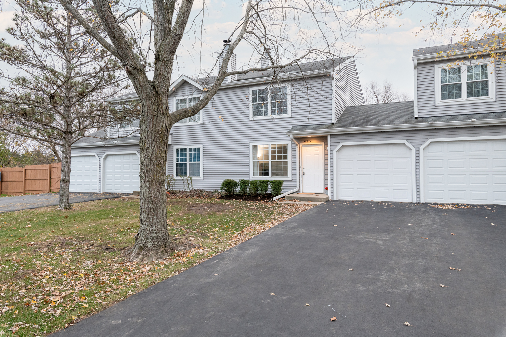 a view of a house with a yard and garage