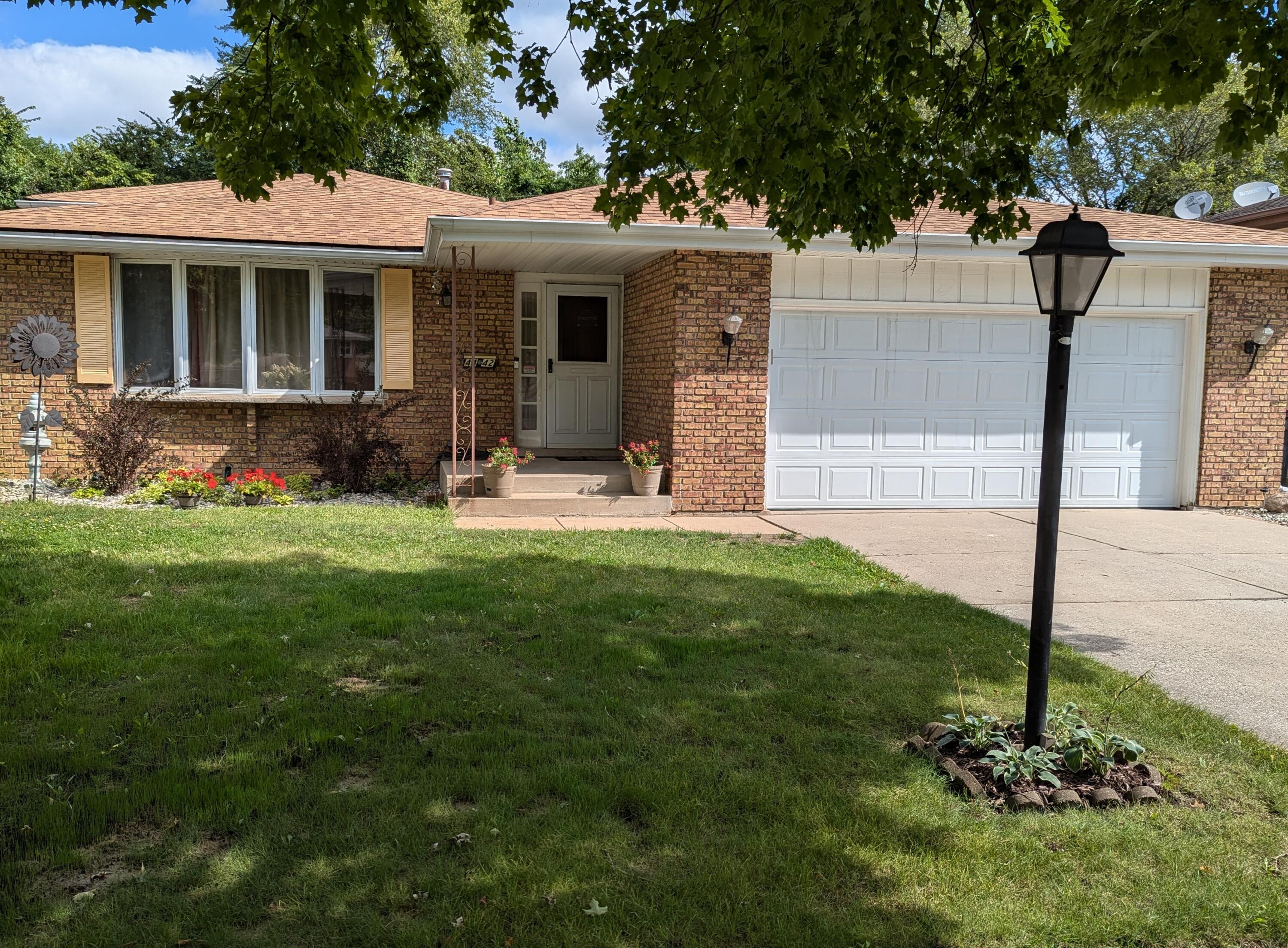 a view of a house with a yard and sitting area