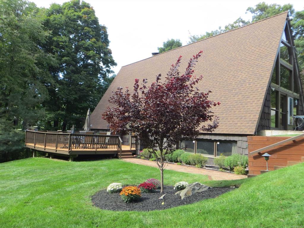 a view of a house with a backyard porch and sitting area