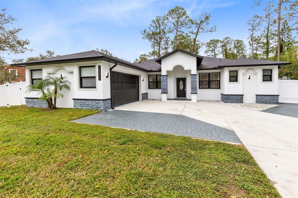 a front view of house with yard outdoor seating and barbeque oven