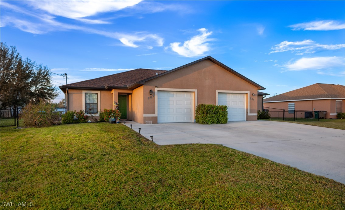 a front view of a house with yard and green space