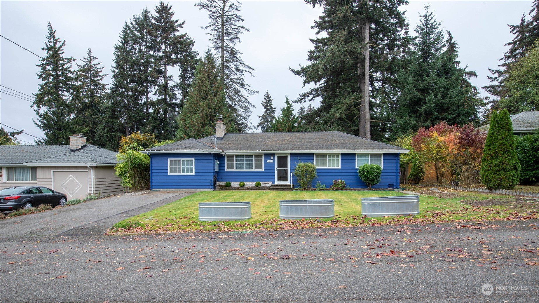 a view of a house with a yard patio and tree