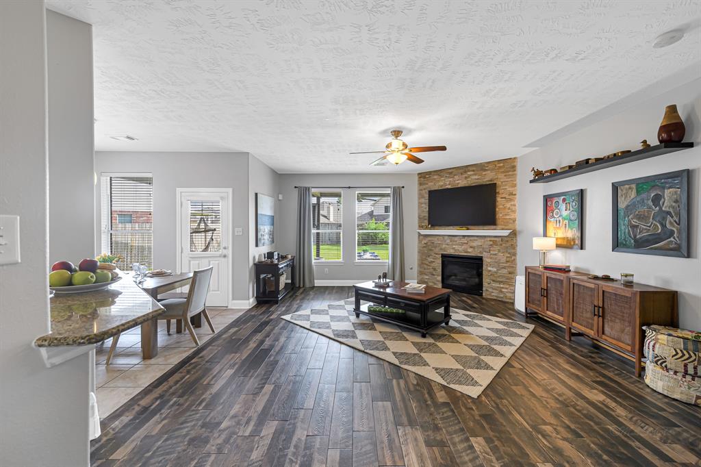 a living room with furniture a fireplace and a flat screen tv