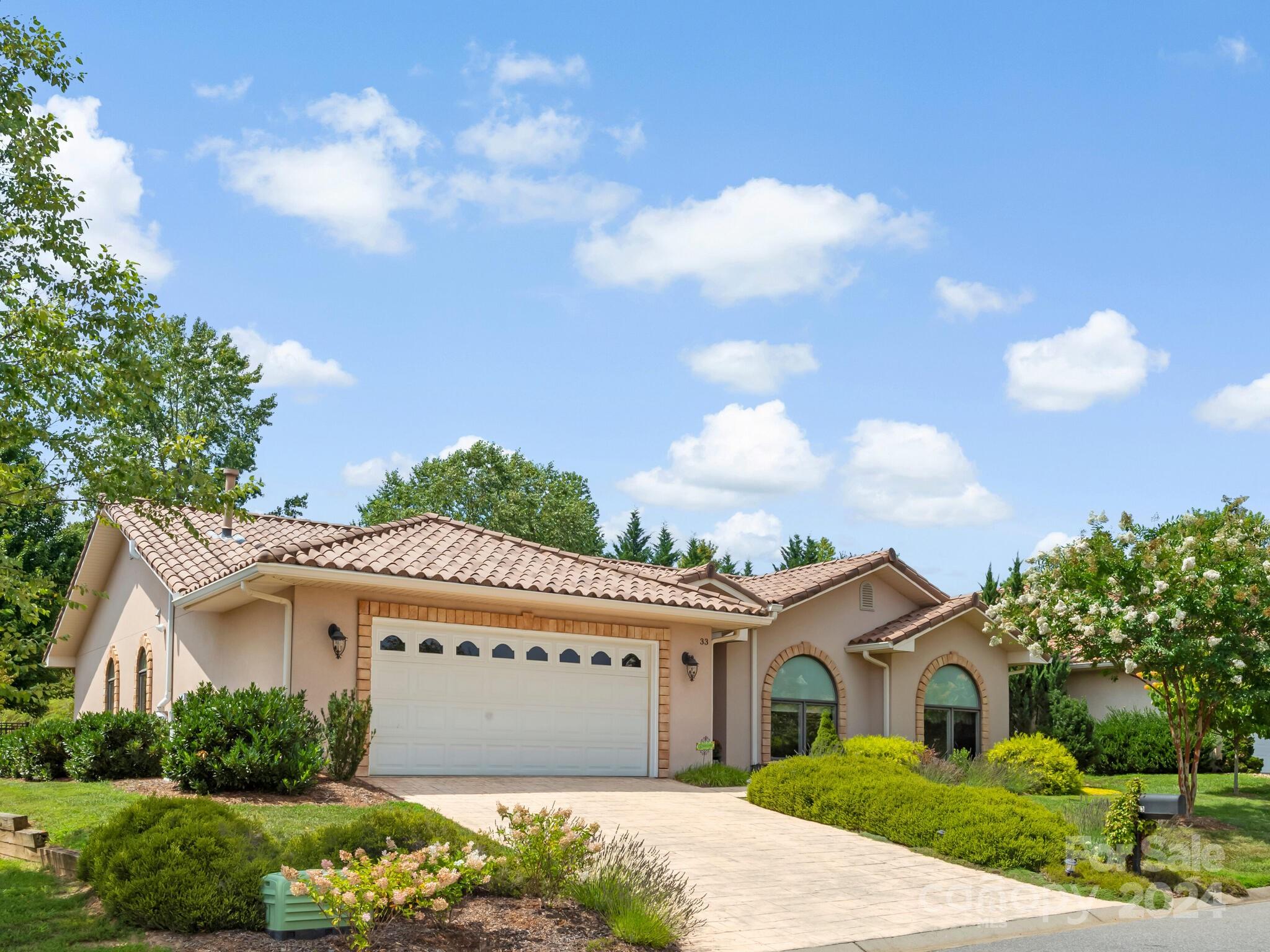 a front view of a house with a garden