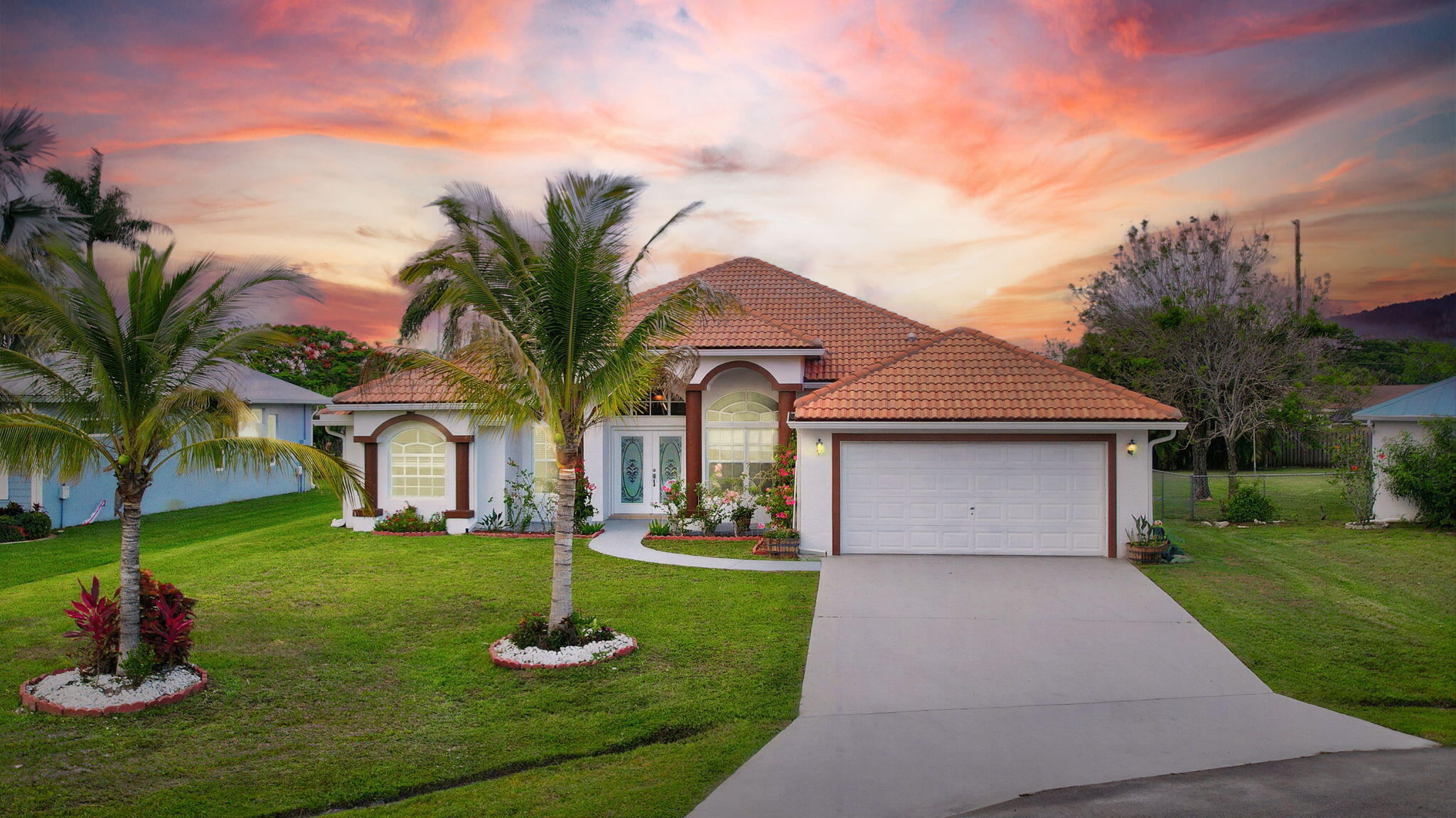 a front view of a house with a yard and garage