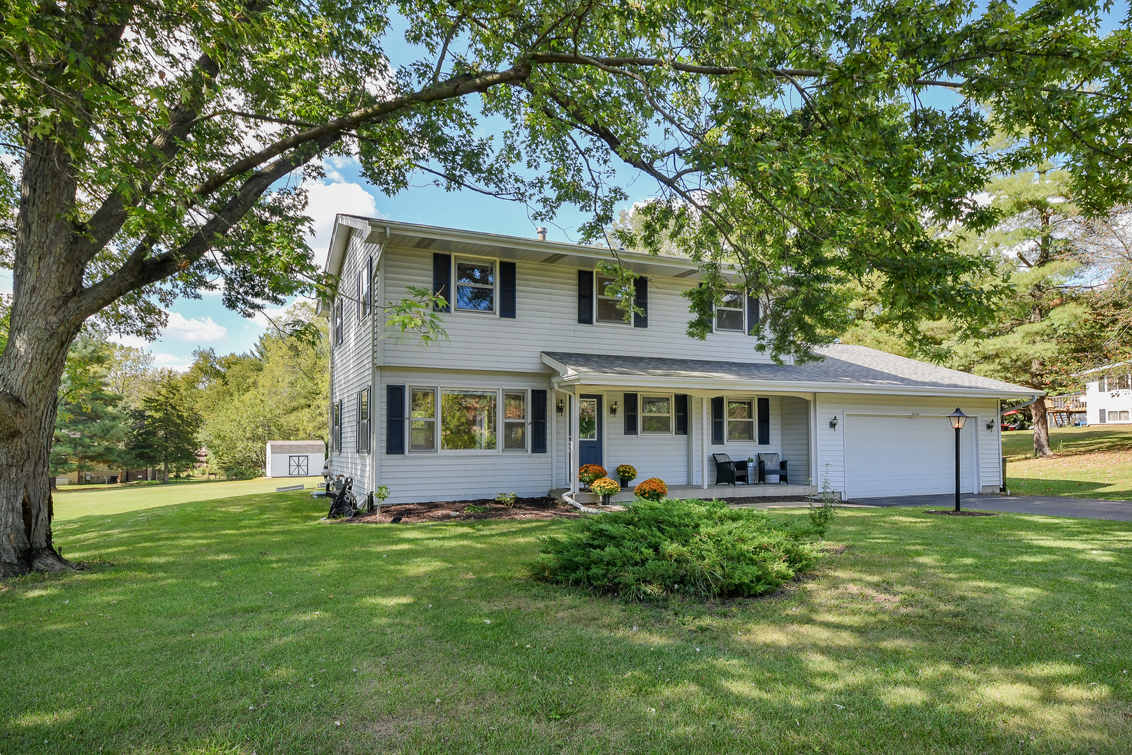 a front view of house with yard and green space