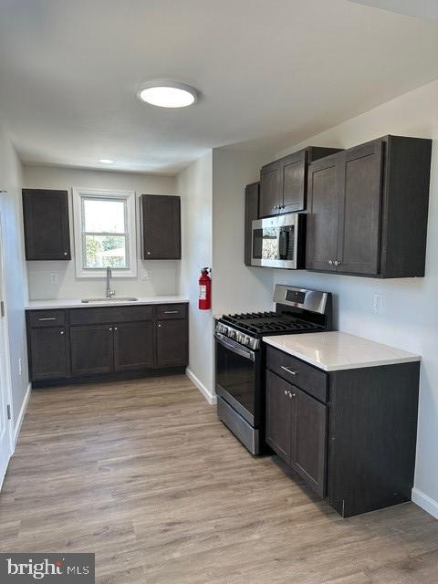 a large kitchen with stainless steel appliances granite countertop a stove a sink and a microwave