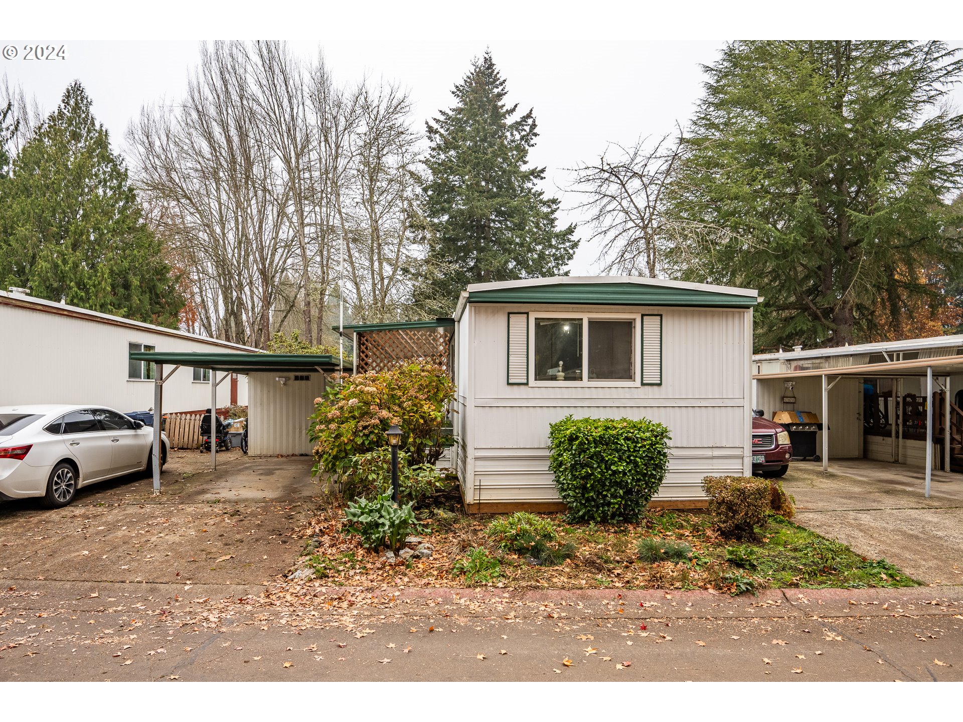 a view of a house with a backyard and a garage