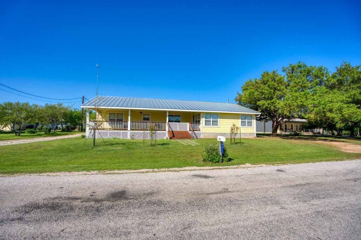 a view of a house with a yard and pathway