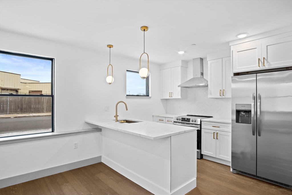 a kitchen with a sink stove and refrigerator