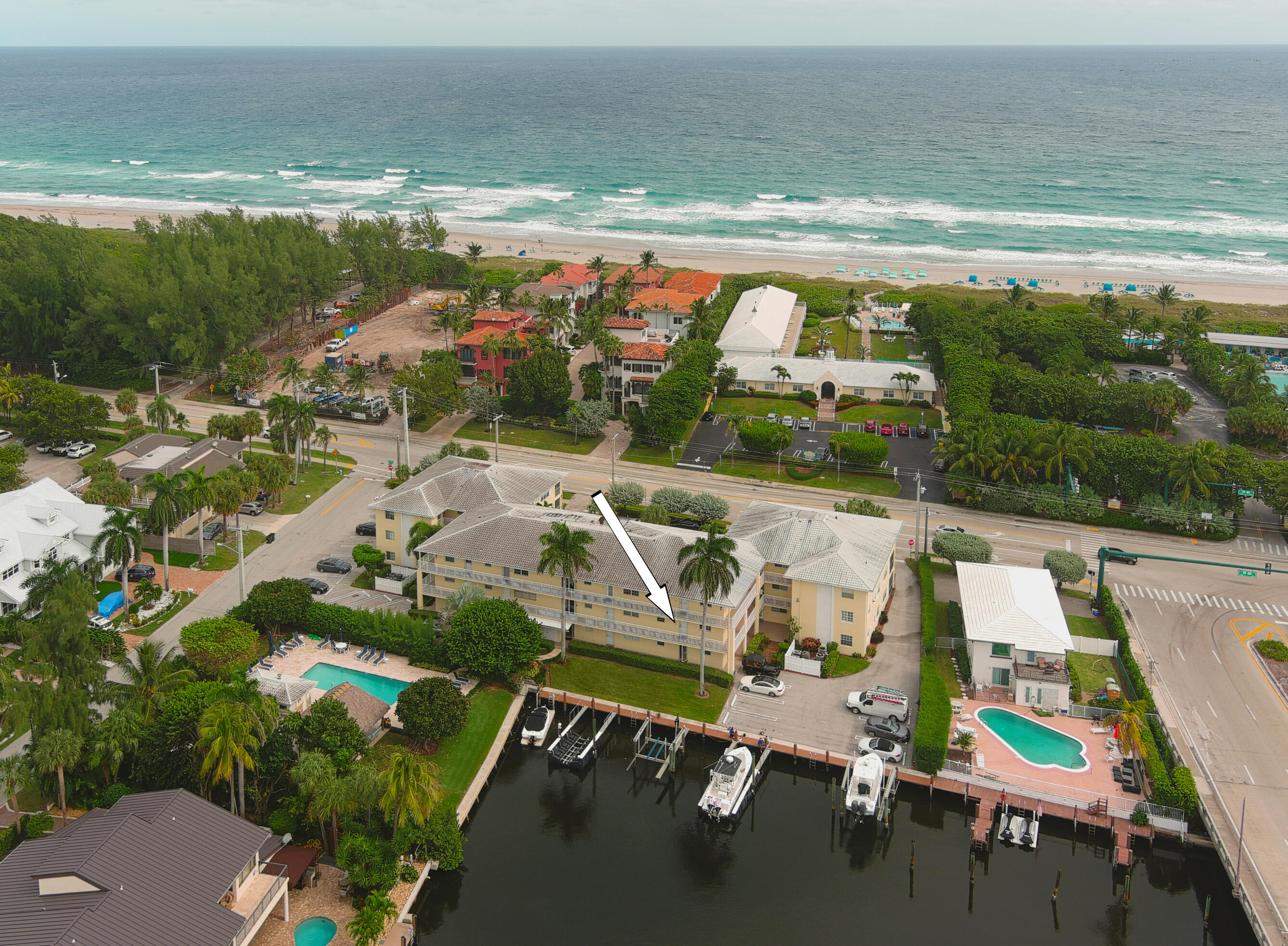 a view of swimming pool with outdoor seating and ocean view