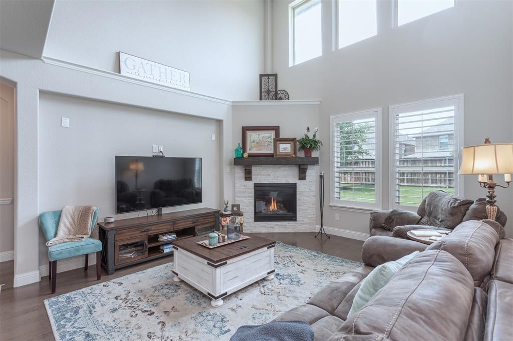 a living room with furniture flat screen tv and a fireplace