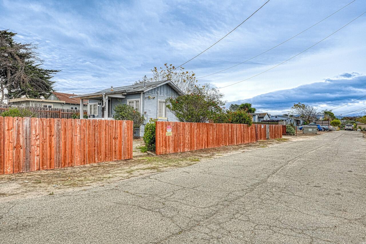 a view of a backyard with wooden fence