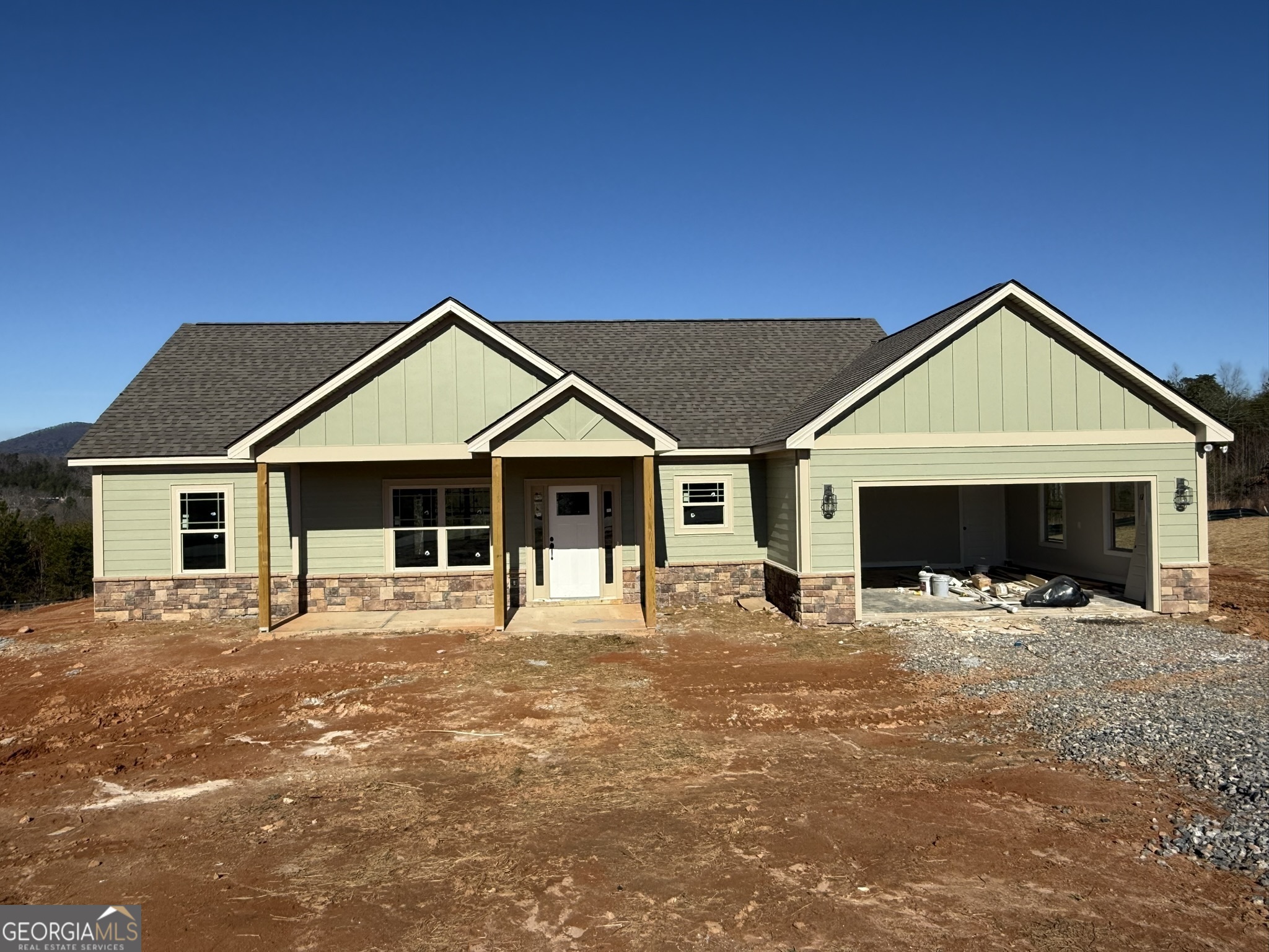 a front view of a house with yard and porch