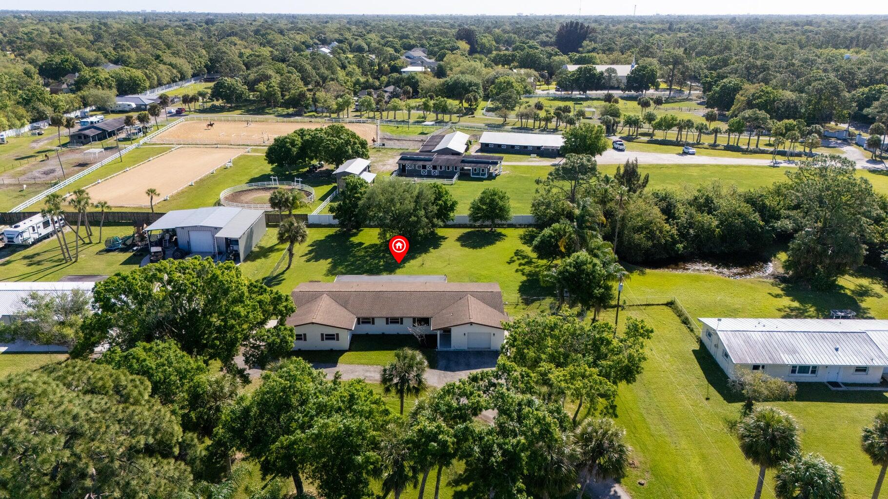 an aerial view of residential houses with outdoor space and swimming pool