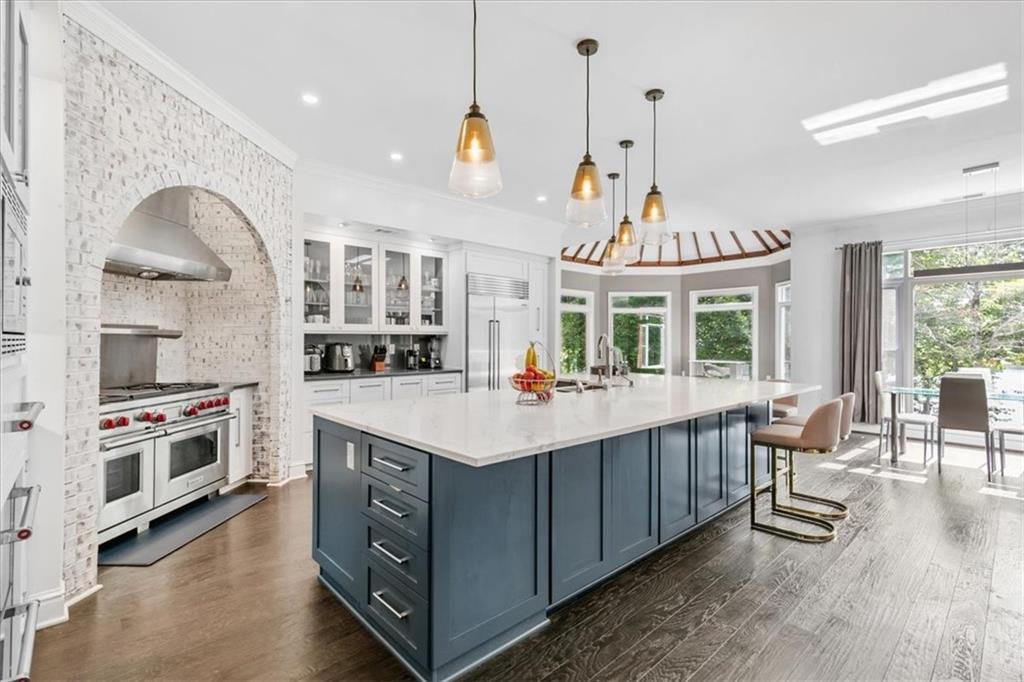 a kitchen with stainless steel appliances a stove and more cabinets