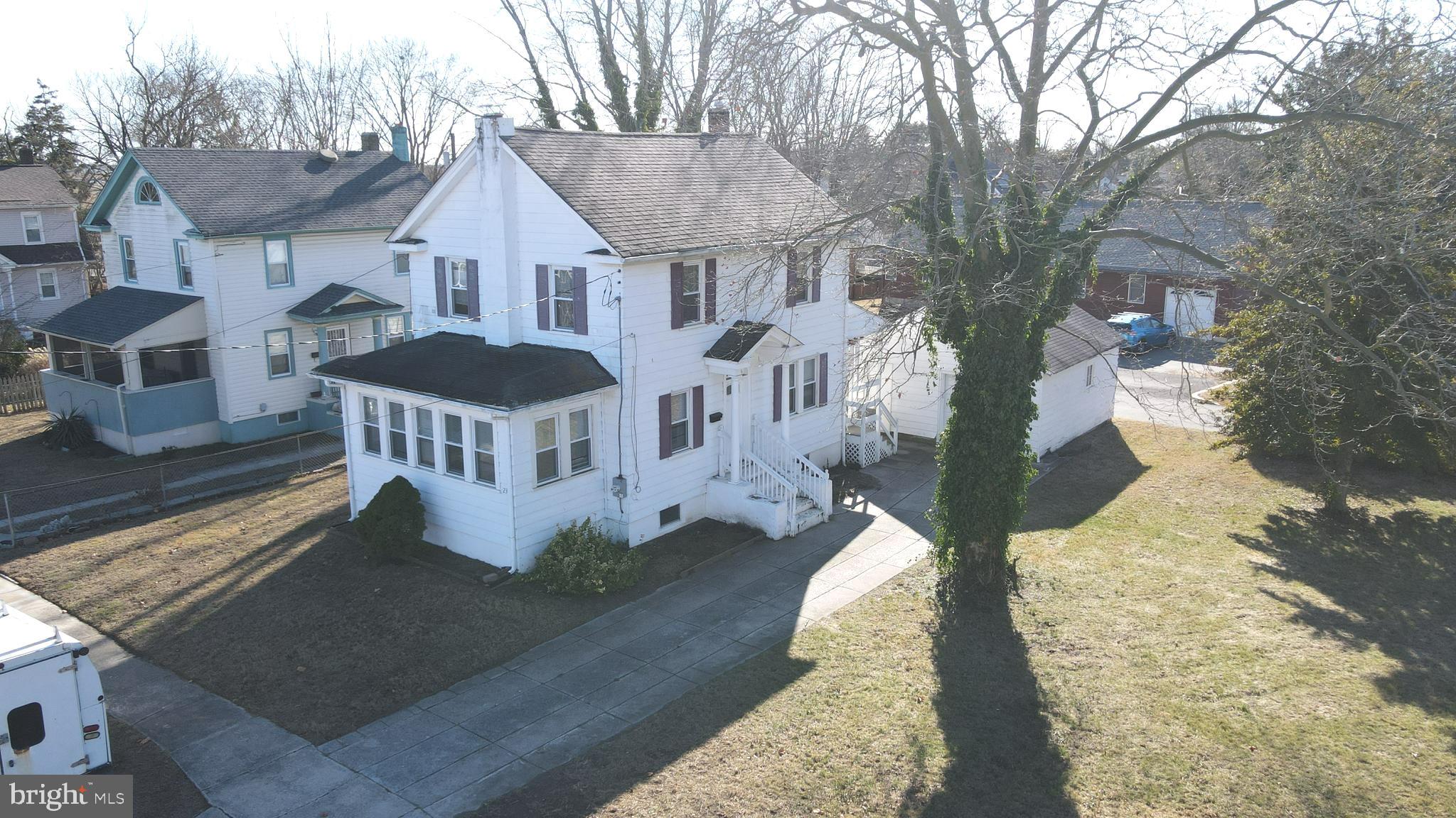 a front view of a house with a yard garden and outdoor seating