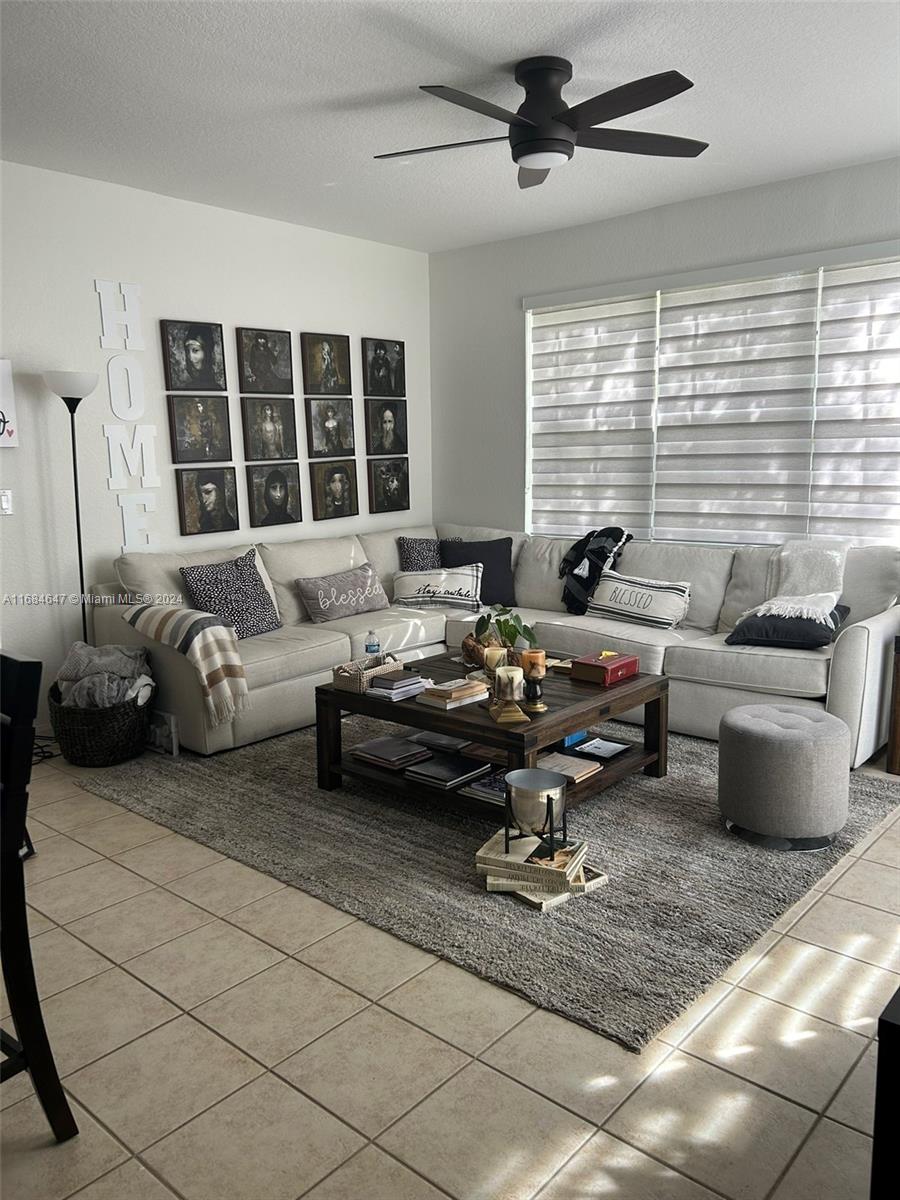 a living room with furniture and a large window