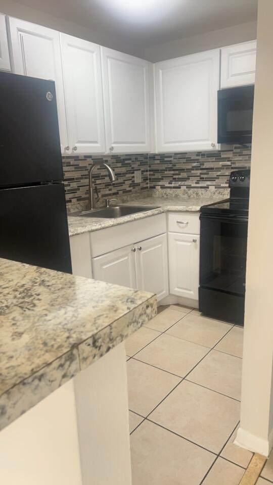 a kitchen with granite countertop a sink and a stove