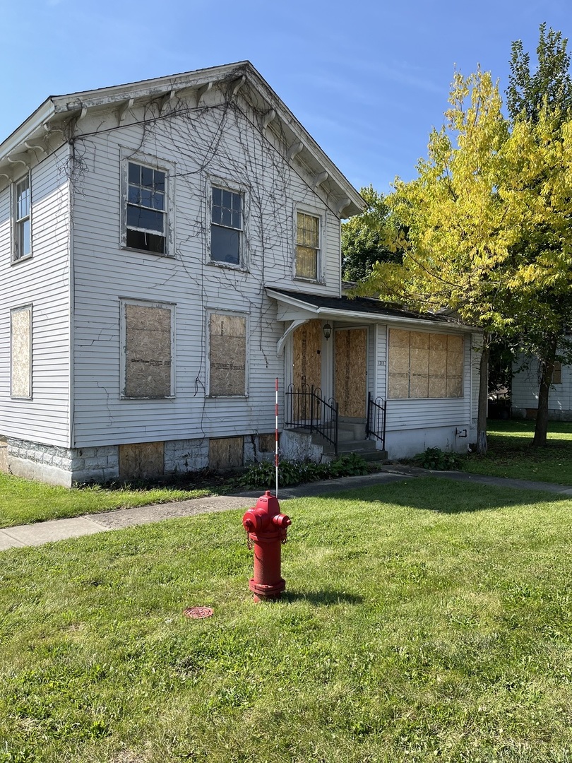 a house view with a sitting space and garden