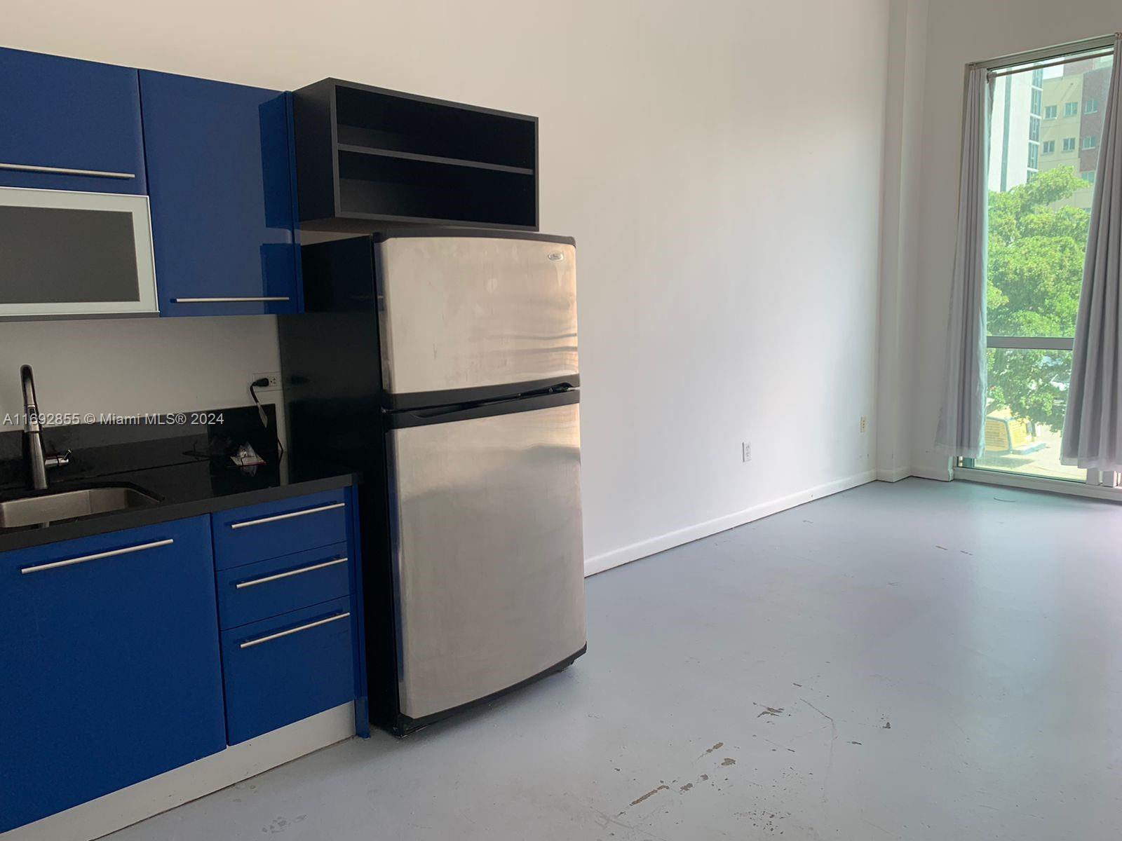 a kitchen with a refrigerator and a microwave