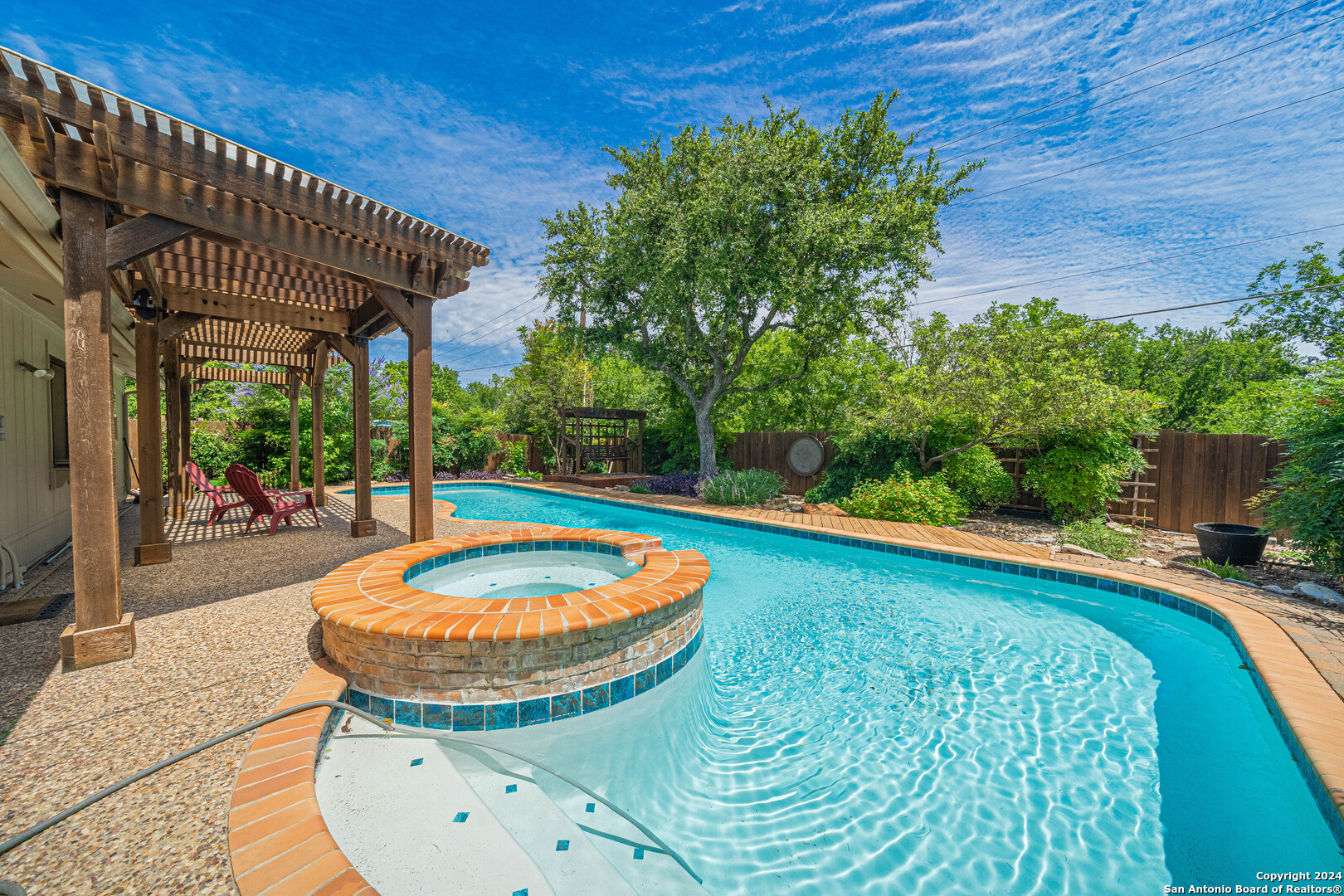 a view of a swimming pool with a patio and a yard