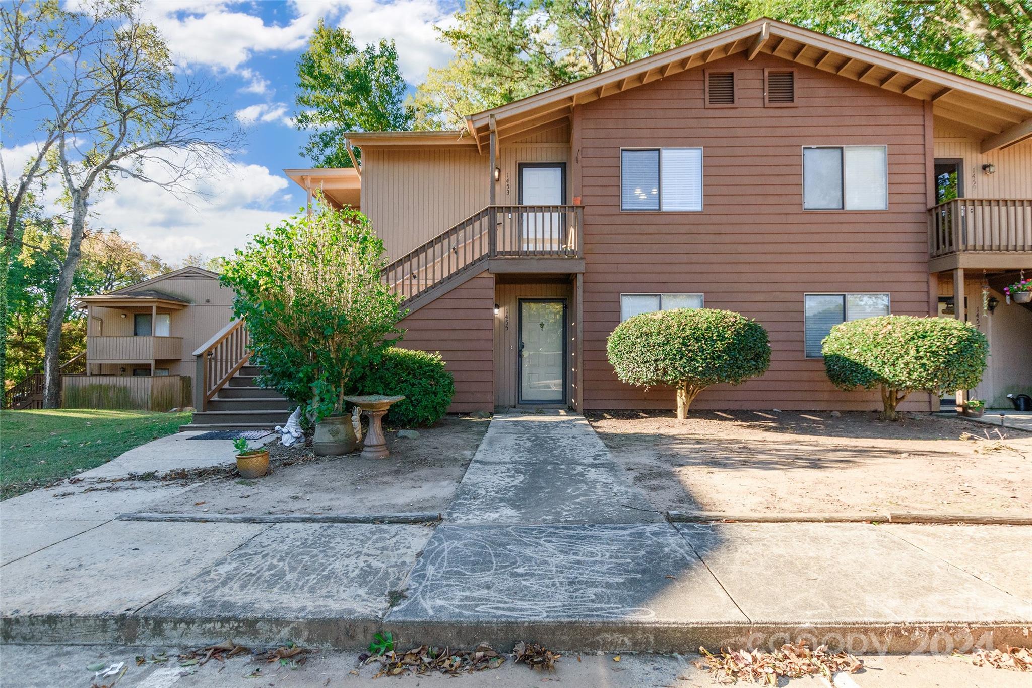 a front view of a house with garden