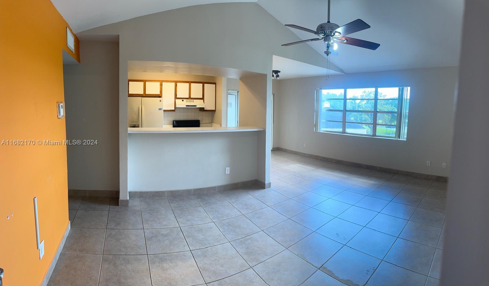 a view of livingroom and kitchen with hardwood floor and window