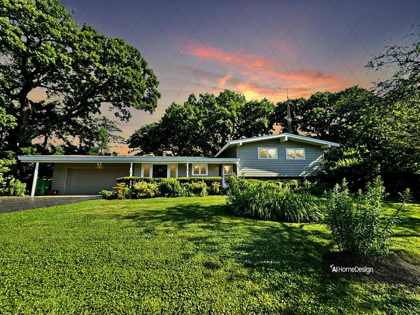 a front view of a house with a garden and trees