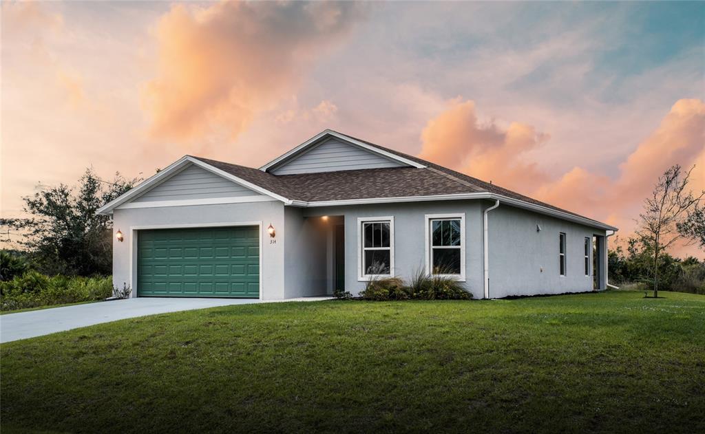 a view of a house with a yard and garage