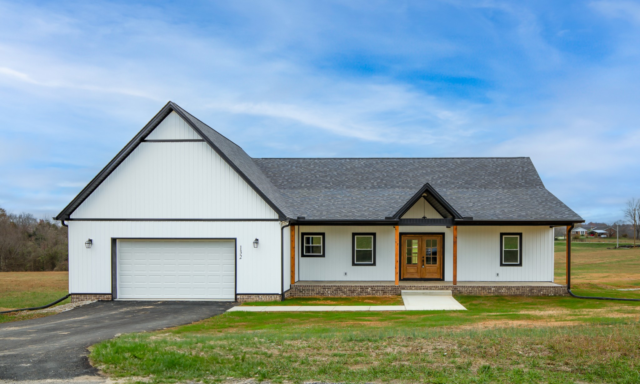 a front view of a house with a yard and garage