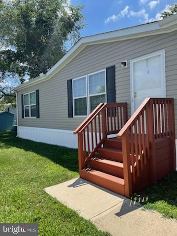 a view of a house with backyard and wooden fence