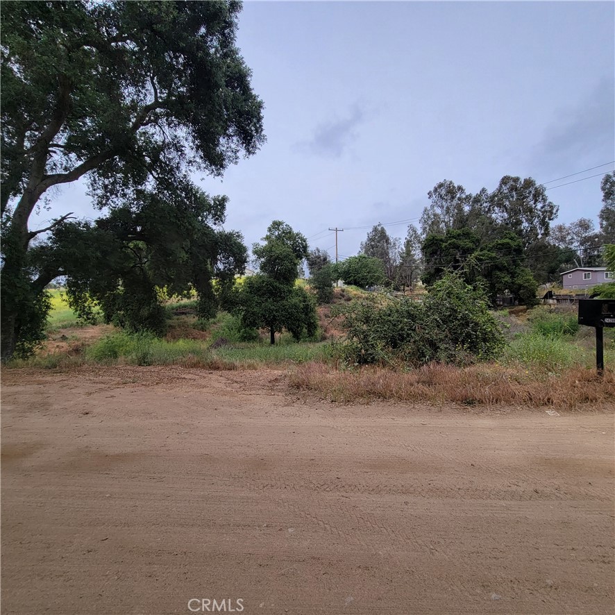 a view of a dirt road and a building