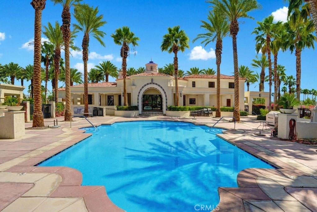 a swimming pool with outdoor seating and yard