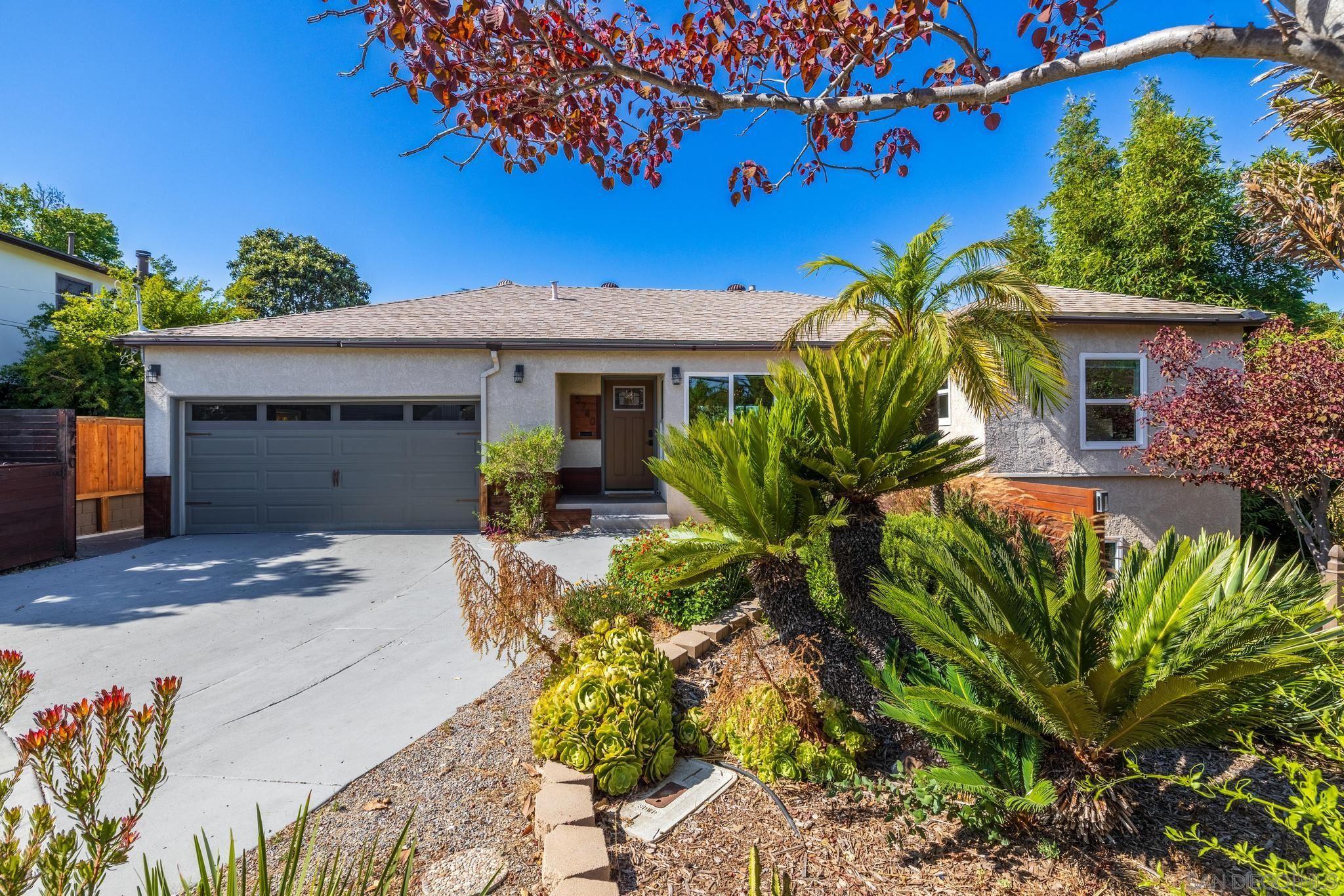 a front view of a house with a yard and a garage