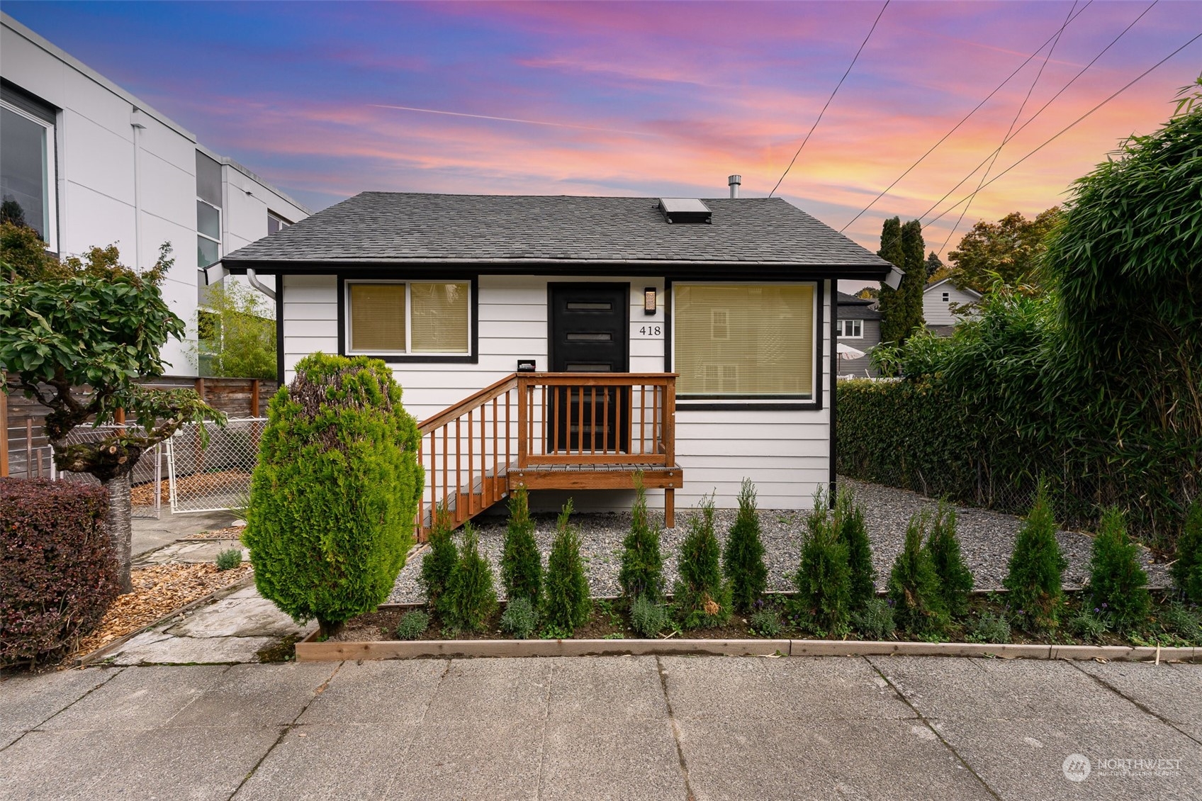 a front view of a house with a garden