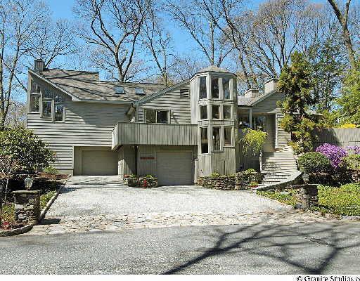 a front view of a house with yard and seating area