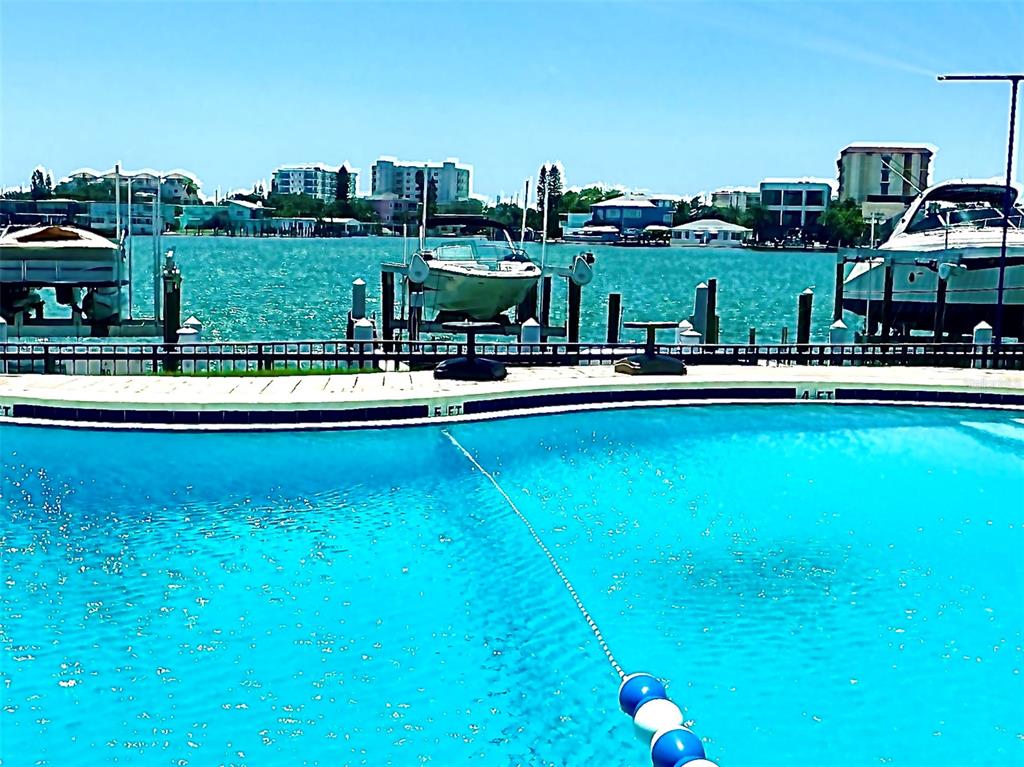 a view of a swimming pool with lawn chairs