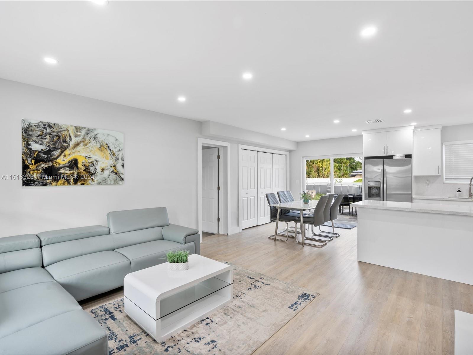 a living room with furniture and kitchen view