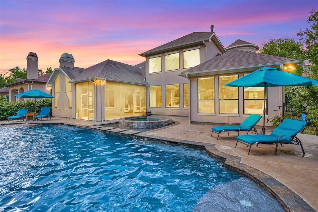 a view of a house with backyard and sitting area