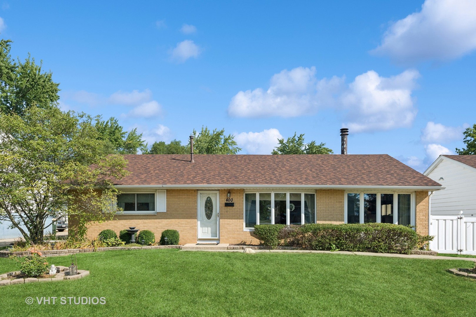 a front view of a house with a yard