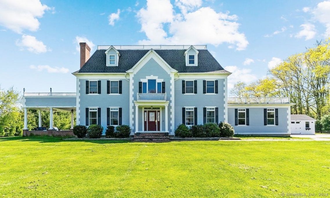 a front view of house with yard and outdoor seating