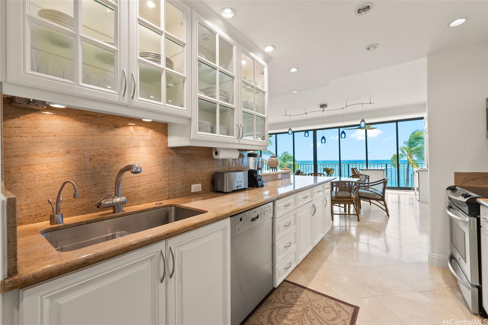 a kitchen with stainless steel appliances granite countertop a sink and cabinets