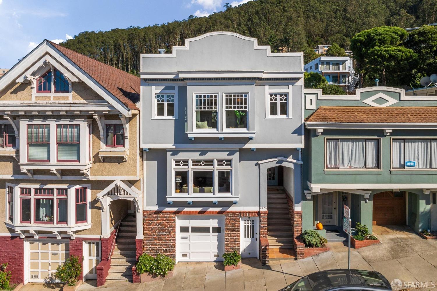 a front view of a residential apartment building with a yard